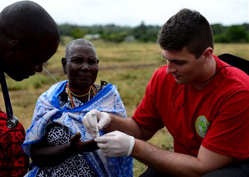 U.S. Air Force Capt. Andrew Christo, 104th Fighter Wing Massachusetts Air National Guard registered nurse, cares for a patient during medical outreach June 22, 2016 at Lokusero, Kenya. The medical outreach was part of the first African Partnership Flight in Kenya. Over the course of three days, medical assistance was provided for more than 1,250 patients. The APF is designed for U.S. and African partner nations to work together in a learning environment to help build expertise and professional knowledge and skills. (U.S. Air Force photo by Tech. Sgt. Evelyn Chavez/Released)