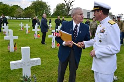  Lt. Col. William Hooker, Jr. (retired) explains to Rear Admiral John G. Messerschmidt, United States European Command, how his father William Hooker, Sr. was killed during fighting in WWII. 
