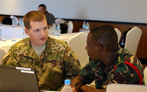 Sgt. Zachery Bunting, a communications sergeant for 1st Battalion, 9th Field Artillery Regiment, 2nd Brigade Combat Team, 3rd Infantry Division, and Capt. Mhelela, a Tanzanian People's Defense Force communications officer, discuss signals requirements for exercise Eastern Accord 2016 during the final planning event in Dar es Salaam, Tanzania, May 3. EA 2016 is an annual, combined, joint military exercise bringing together partner nations to practice and demonstrate proficiency in conducting peacekeeping operations. (U.S. Army Africa photo by Capt. Jarrod Morris)