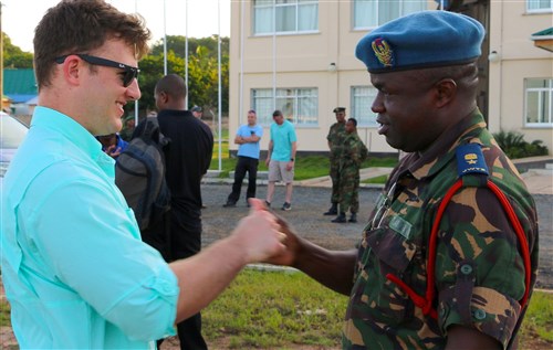 Tanzanian People’s Defense Force Lt. Col. Hozza teaches a popular Tanzanian handshake to Capt. Bryan Neal, operations planner for 1st Battalion, 9th Field Artillery Regiment, 2nd Brigade Combat Team, 3rd Infantry Division, during the exercise Eastern Accord 2016 final planning event site visit to the Tanzanian Peacekeeping Training Center in Dar es Salaam, Tanzania, May 3. Soldiers of 1-9 FA are supporting EA 2016 this summer as part of the regionally allocated force for U.S. Army Africa and U.S. Africa Command. (U.S. Army Africa photo by Capt. Jarrod Morris)