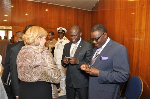 Lorraine Rapp, U.S. Africa Command’s Disaster Preparedness Program manager, exchanges contacts with Nigerian ministers, Dr. Nurudeen Muhammad, Minister of Foreign Affairs, and Professor C.O. Onyebuchi Chukwu, Minister of Health (right), during a ceremony to unveil Nigeria’s Pandemic and Natural Disaster Response Plans in Abuja, Nigeria, November 14, 2013.  So far, AFRICOM has partnered with more than 20 African countries to develop national pandemic response plans. The plans help define the roles various government entities, including the military, would serve in a disaster response. (Photo by Technical Sergeant Olufemi A. Owolabi)