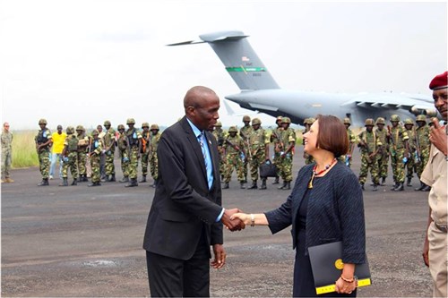 U.S. Ambassador Dawn Liberi and Burundi Minister of Defense MG Poniten Gaciyubwenge shake hands prior to Burundian soldiers boarding a U.S. C-17 aircraft for Bangui, Central African Republic. On Dec. 9, the U.S. government authorized U.S. aircraft to assist the Burundian National Defense Forces with their deployment to Bangui, Central Africa Republic.