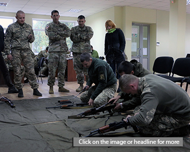 Ukrainian Soldiers disassemble an AK-47 assault rifle during a basic instructor course here, October 12, 2016.