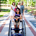 Family with their daughter who is in a wheelchair.