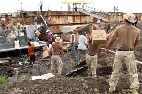 LIMBE, Cameroon (Dec. 6, 2007) -- U.S. sailors work hand-in-hand with Cameroonians from Buea Diocese to offload nearly 500 boxes of a rice-soy food product from a landing craft during an Africa Partnership Station Project Handclasp donation. The donation, coordinated with the U.S. Embassy, will provide approximately 107,000 meals for AIDS/HIV orphans and adults, and other vulnerable children as part of a government-endorsed Catholic Relief Services and Buea Diocese AIDS/HIV project supporting the local population. Project Handclasp is an official U.S. Navy program which coordinates transportation and delivery of humanitarian, educational, and goodwill material for distribution by Naval forces worldwide. The American sailors are with  Assault Craft Unit (ACU) 2 and the USS Fort McHenry (LSD 43).(U.S. Navy photo)