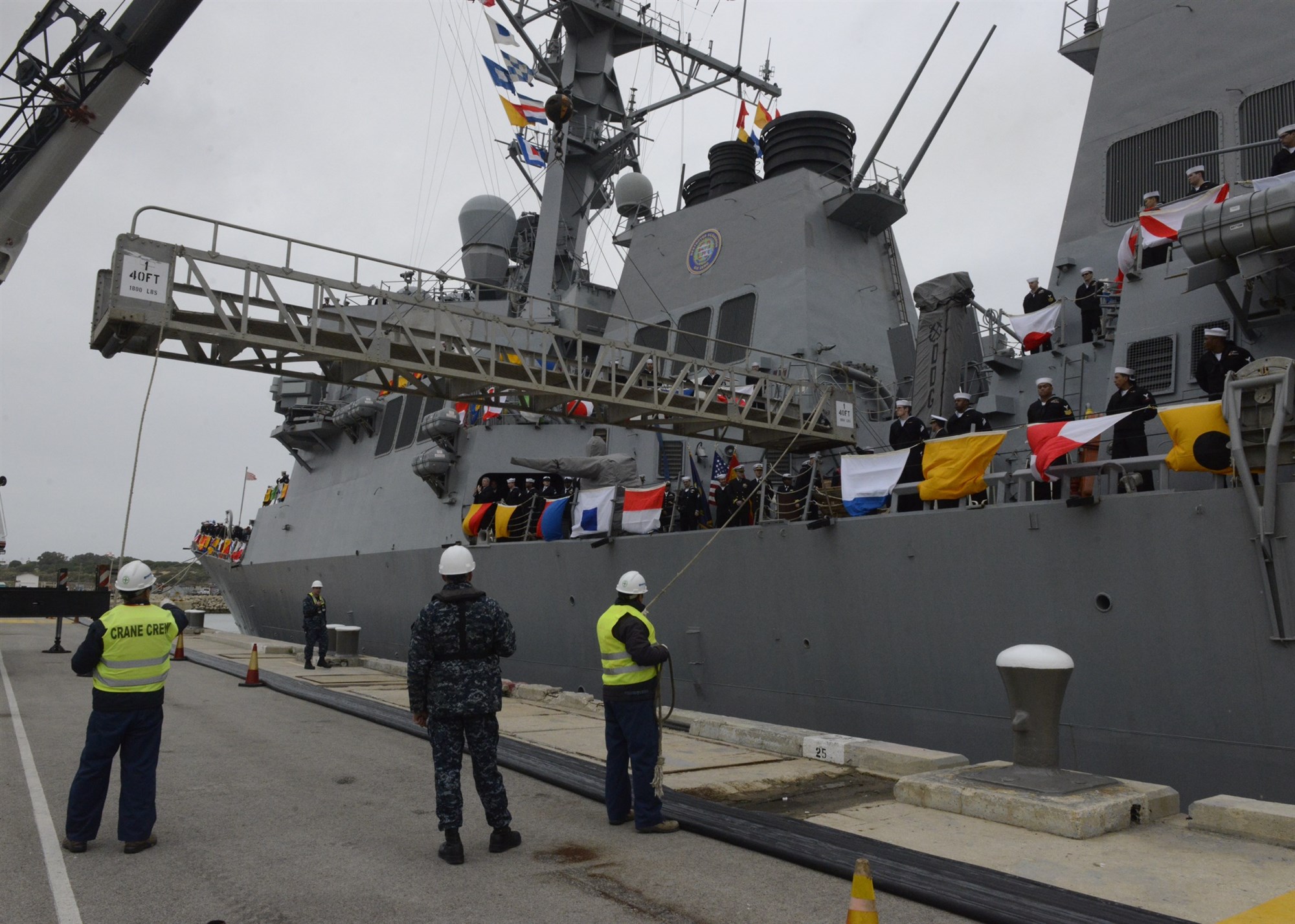 ROTA, Spain (Feb. 11, 2014) Sailors aboard the guided-missile destroyer USS Donald Cook (DDG 75) man the rails as the ship arrives in Rota, Spain. Donald Cook is the first of four Arleigh Burke-class guided-missile destroyers to be stationed in Rota. 