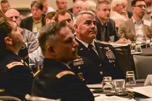 BG Kaiser listening to LTC Michael Sellers address the USACE Construction &amp; Contracting Personnel and representatives from the Construction Contractors at the 2015 Construction Roundtable.

