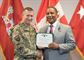 Maj. Gen. Robert Carlson presents Donn Booker with a Department of Army Meritorious Civilian Service Award during a retirement ceremony Sept. 29 in Winchester, Va.  