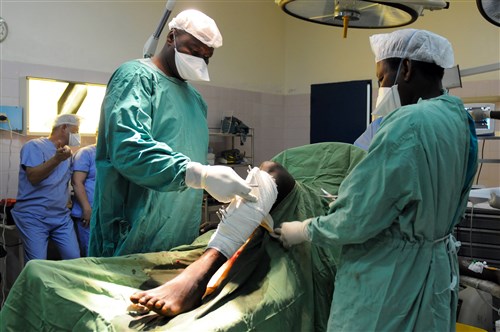 A joint team Chadian and U.S. military medical professionals work together during a surgery April 14 at the Military Teaching Hospital in N’Djamena, Chad. They performed a procedure on a Chadian soldier who sustained a gunshot wound that fractured his right femur and left tibia. The U.S. and Chadian medical teams are working together as part of a joint exercise called Medical Readiness and Training Exercise known as MEDRETE 15-3. The exercise is a joint effort between the Chadian government, U.S. Army Africa, the Army Reserve Medical Command and the 7th Civil Support Command. MEDRETE 15-3 serves as an opportunity for U.S. and Chadian forces to hone and strengthen their life saving skills as well as reinforce the partnership between both countries. (U.S. Army Africa photo by Staff Sgt. Andrea Merritt)