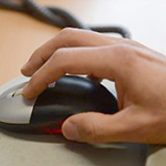 Hand on computer mouse