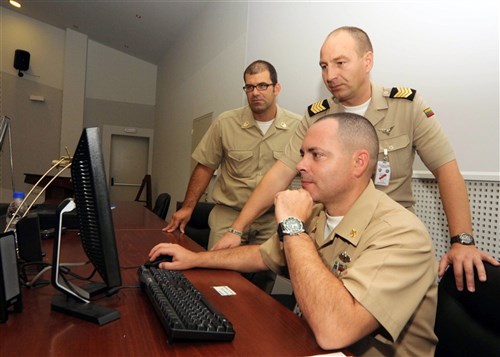 SOUDA BAY, Greece &mdash; Navy Senior Chief Intelligence Specialist Matthew Skaggs (right), reviews a training plan on non-commissioned officer development with Master Chief Petty Officer Gediminas Zabitis, Master Chief Petty Officer of the Navy of Lithuania (middle), and Senor Chief Petty Officer Andreas Baroutsos, Greek Navy (left), at the NATO Maritime Interdiction Operations Training Center at Marathi Pier
as part of Eurasia Partnership Capstone 2009 (EPC 09).  Military forces from 11 countries will participate in a conference for maritime forces in Souda Bay, Greece Sept. 19-26.  Annually hosted by the U.S. Navy, EPC 09 aims to increase maritime safety and security through open and transparent sharing of information in a non-formal environment such as workshops and seminars. Nations participating in EPC &#39;09 will include Azerbaijan, Bulgaria, Georgia, Greece, Kazakhstan, Latvia, Lithuania, Norway, Poland, Ukraine, and the United States. (Department of Defense photo by Navy  Ma