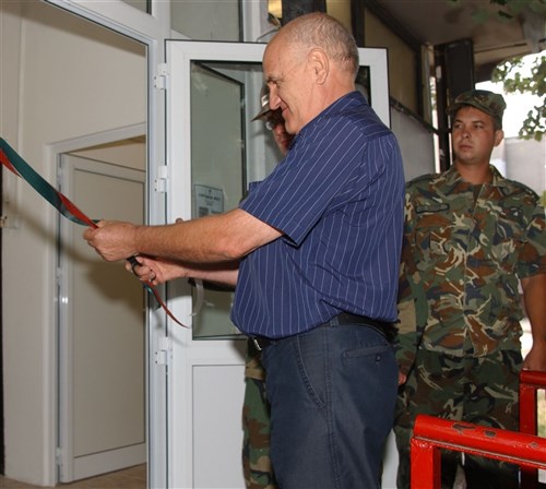 SLIVEN, Bulgaria &mdash; Toncho Tonchev, president of the Dame Gruev Center for the Disabled in Sliven, cuts a red ribbon officially reopening the center during a ceremony held Aug. 10. Tonchev said this is the first renovation since it opened nearly 17 years ago. (Department of Defense photo by U.S. Army Spc. Sophia R. Lopez)