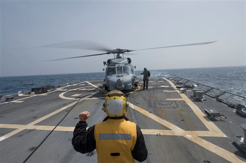 Boatswain's Mate Seaman Jon Parker, from Warren, Ohio, center, signals to pilots operating an MH-60R Sea Hawk helicopter assigned to Helicopter Maritime Strike Squadron (HSM) 46, while Aviation Electronics Technician 3rd Class Logan Smith, from Jacksonville, Florida, disconnects a data link from the aircraft prior to take-off aboard USS Jason Dunham (DDG 109) April 17, 2015. Jason Dunham, an Arleigh Burke-class guided-missile destroyer, homeported in Norfolk, is conducting naval operations in the U.S. 6th Fleet area of operations in support of U.S. national security interests in Europe. (U.S. Navy photo by Mass Communication Specialist 3rd Class Weston Jones/Released)