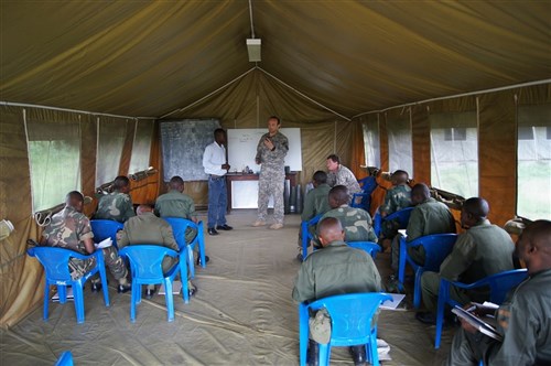 KISANGANI, Congo - U.S. Explosive Ordnance Disposal (EOD) instructors with the Humanitarian Mine Action program teach a portion on ordnance identification to a group of Congolese soldiers with the Forces Armees de la Republique Democratique du Congo (FARDC) , April 2012. The main objective of this exercise is to improve the FARDC deminers' EOD skill sets to a point where they can set up a sustainable program in the DRC. (U.S. Army photo by Captain Charles A. Schnake)     