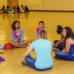 Girls sitting in a circle, talking during a retreat