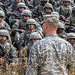 Army officer facing a platoon of soldiers