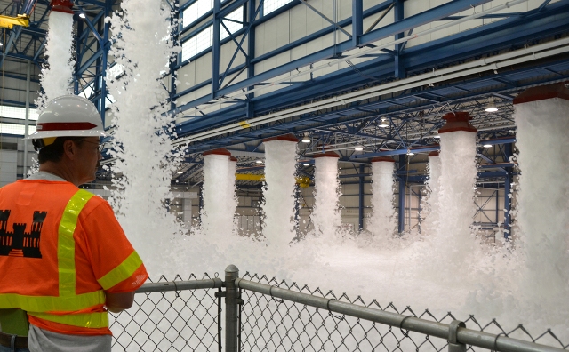 A U.S. Army Corps of Engineers fire protection specialist oversees a fire protection HEF drop test. The HEF expands to fill large enclosed spaces to suffocate fire.