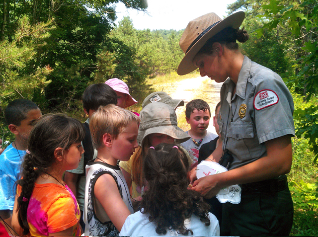 A park ranger speaks to children during an interpretive program at a USACE recreation center.