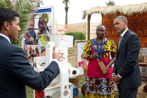 USAID Administrator Rajiv Shah speaks to President Obama and an expo participant June 28 at the Feed the Future Technology Marketplace in Senegal.