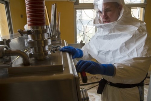 Capt. Shawn Palmer, a biochemist with the 1st Area Medical Laboratory, based out of Aberdeen Proving Ground, Md., and a native of Loma, Colo., breaks down a biological safety level three glove box at the 1st AML’s Ebola testing lab in Zwedru, Liberia, Feb. 9, 2015. The glove box is built to provide maximum personnel and environmental protection from high-risk biological agents. Soldiers of the 1st AML used this equipment to test blood samples of suspected Ebola patients. This, along with other equipment, was decontaminated and packed away as 1st AML closed the Zwedru lab. Operation United Assistance is a Department of Defense operation in Liberia to provide logistics, training and engineering support to U.S. Agency for International Development-led efforts to contain the Ebola virus outbreak in western Africa. (U.S. Army photo by Staff Sgt. Terrance D. Rhodes, Joint Forces Command – United Assistance Public Affairs/RELEASED)