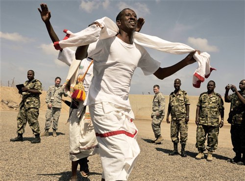 A Djiboutian air force member performs a traditional dance as part of a cultural exchange during African Partnership Flight–Djibouti at Djibouti Air Base, Feb. 9, 2015. APF is the premiere program to bring together partner nations to increase cooperation and interoperability, which fosters stability and security throughout the continent. (U.S. Air Force Photo by Tech. Sgt. Ian Dean) 