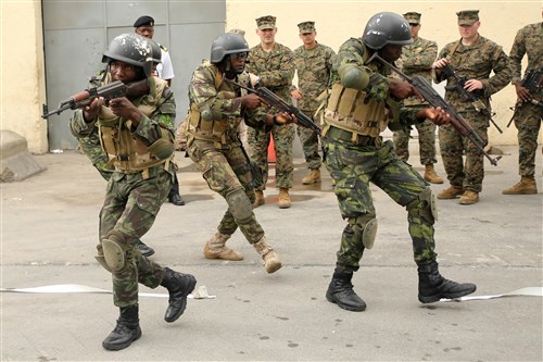 Angolan Marines, known as Fuzileiros Navais da Marinha de Guerra Angolana (MGA), practice  clearing a room in Luanda, Angola, March 4, 2015. U.S. Marines, British Royal Marines and Spanish Marines spent three days training with the Angolans in close-quarters combat, small boat operations and repair, and search and seizure techniques before departing for Cameroon during the maritime security exercise, Africa Partnership Station. (Official U.S. Marine Corps photo by Staff Sgt. Steve Cushman/Released)