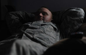 Service member sleeps on bed