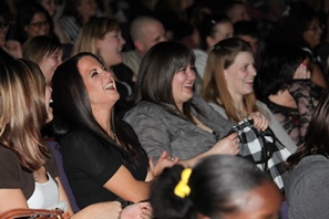 Women laughing during comedy show