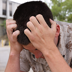 Service member with his head down.