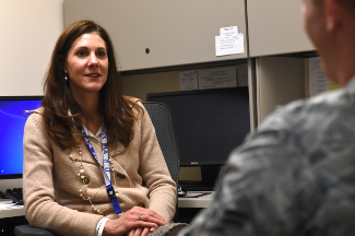 Image of woman listening to service member