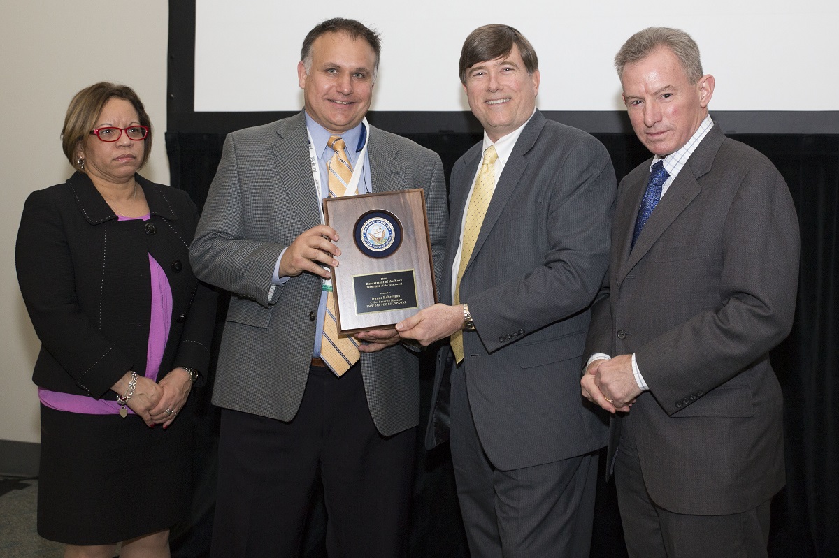 Mr. Robert Foster, Department of the Navy Chief Information Officer (DON CIO); Ms. Janice Haith, Director, DON Deputy CIO (Navy); and Mr. Kenneth Bible, Deputy Director, HQMC C4, U.S. Marine Corps, presented a DON Information System Security Manager (ISSM)/Information System Security Officer (ISSO) of the Year Award to Duane Robertson, Cyber Security Manager, PMW 240, PEO EIS, SPAWAR during the awards ceremony at the DON IT West Coast Conference on February 17, 2016.

