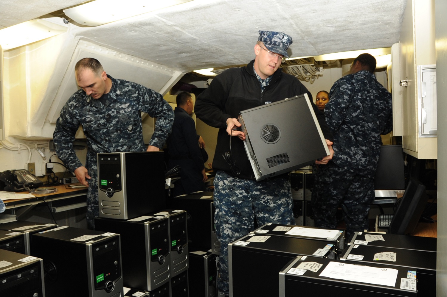 Sailors assigned to the command, control, communications, computers, combat and intelligence department (C5I) aboard the amphibious assault ship Pre-commissioning Unit (PCU) America (LHA 6) organize computers to deploy and install throughout the ship. U.S. Navy photo