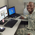 Service member at computer with Blended Retirement System training on screen