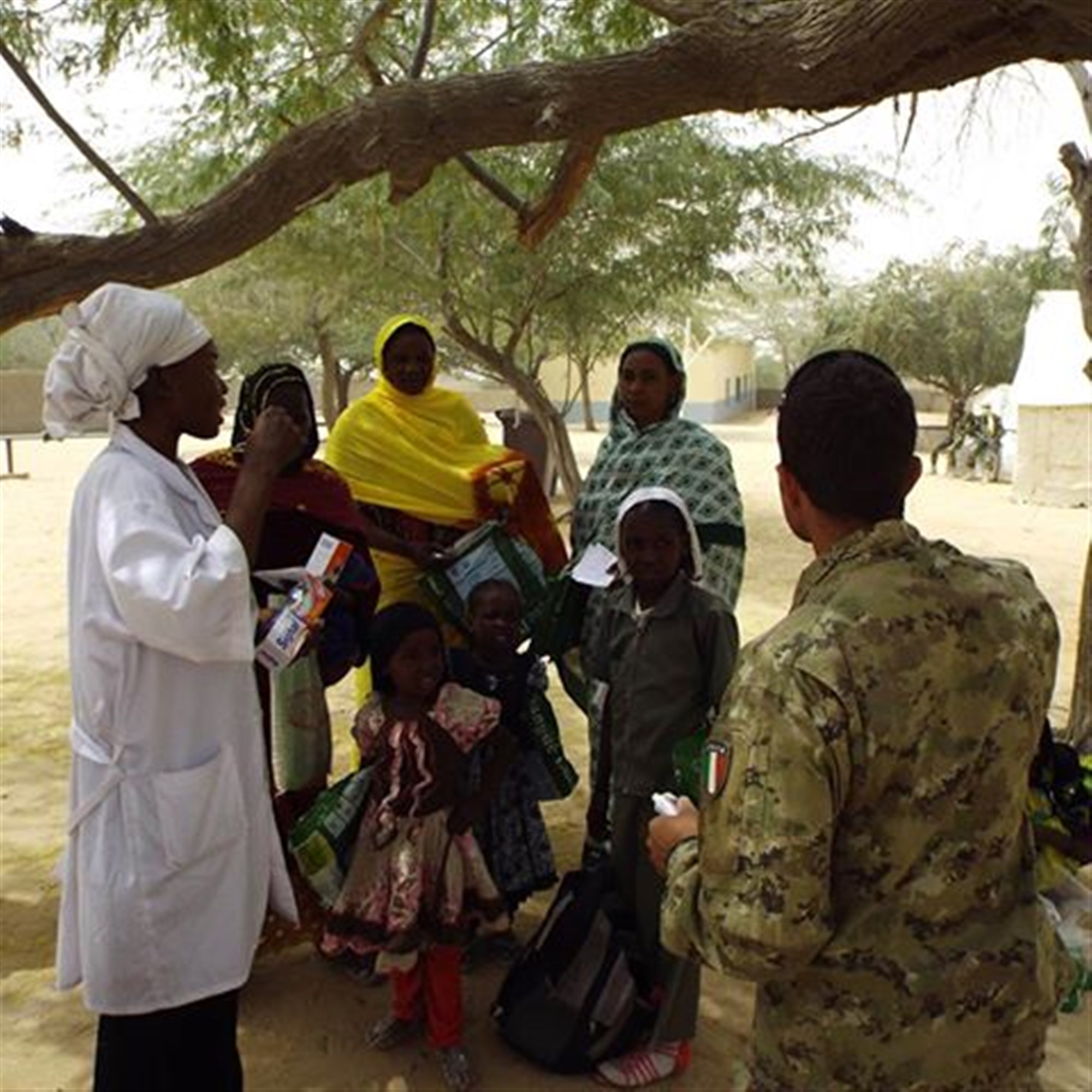 Chadians receive information about treatment from medical care personnel during Exercise Flintlock 2015.