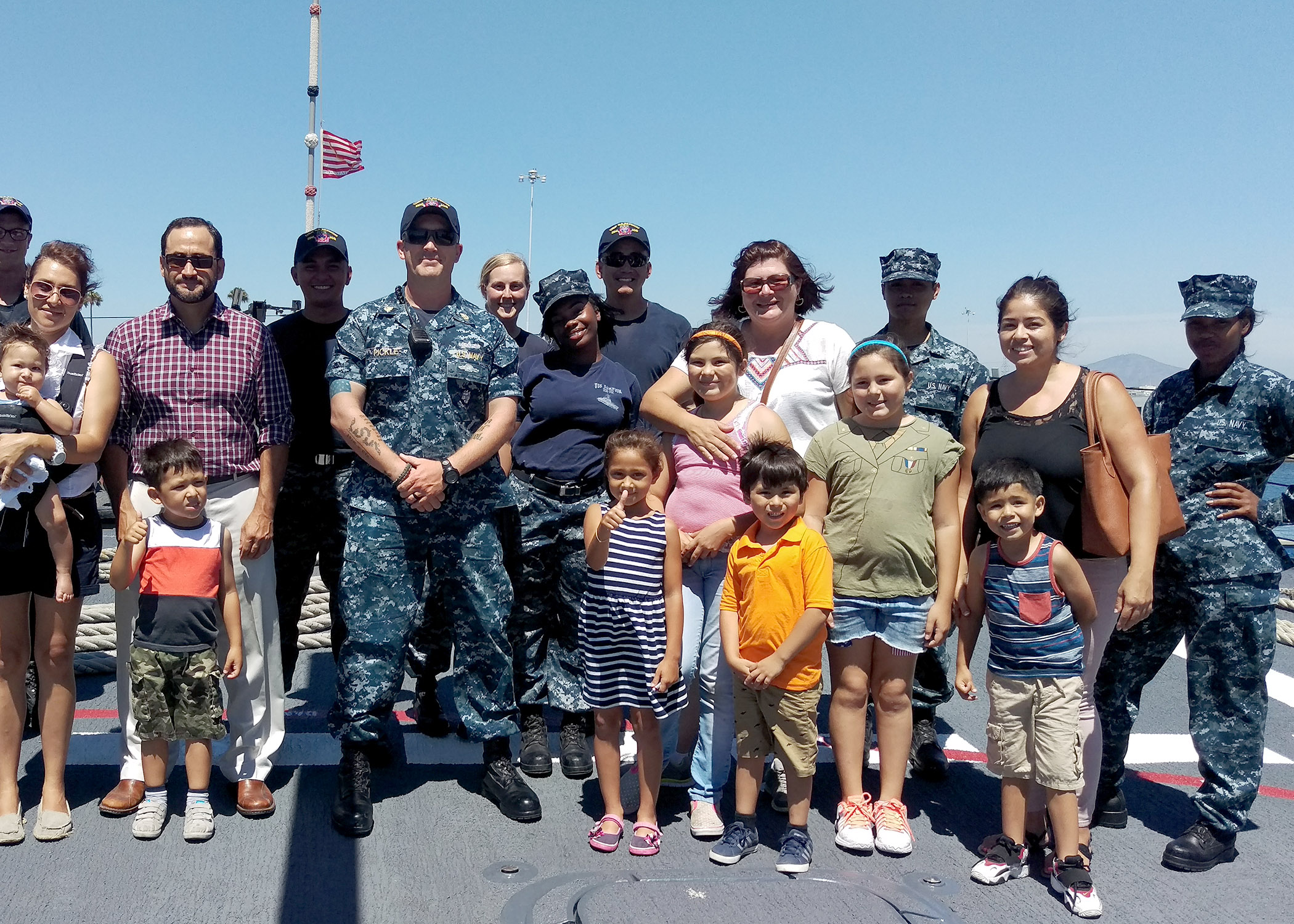 Naval Information Forces West provided a tour of the Naval Base San Diego to local students and their parents July 22.  The families belong to the Marlow B. Martinez Foundation, a local non-profit organization supporting disadvantaged children. Members of the USS Sampson DDG-102 Deck Division took time to pose for a group photo. U.S. Navy photo by LCDR Henry A. Martinez. 