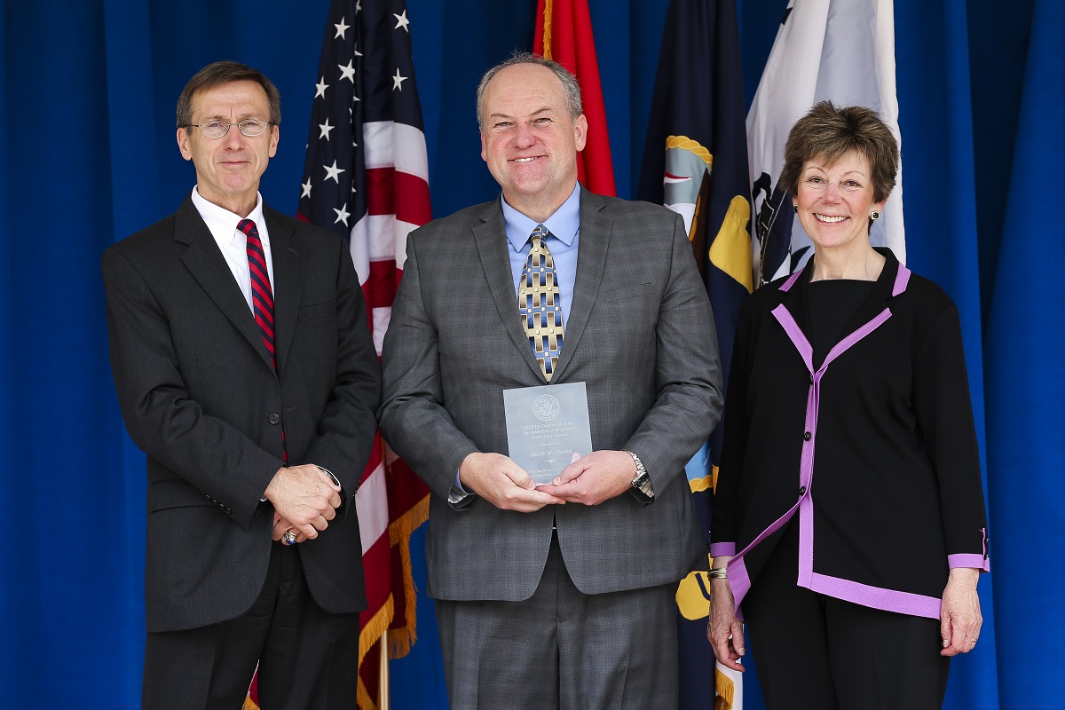 Sean Stackley, assistant secretary of the Navy for Research, Development and Acquisition and Dr. Delores Etter, present Mark Owen with the 2015 Dr. Delores M. Etter Top Scientists & Engineers of the Year Award. U.S. Navy photo by Matthew Poynor, Naval Surface Warfare Center Indian Head Explosive Ordnance Disposal Technology Division