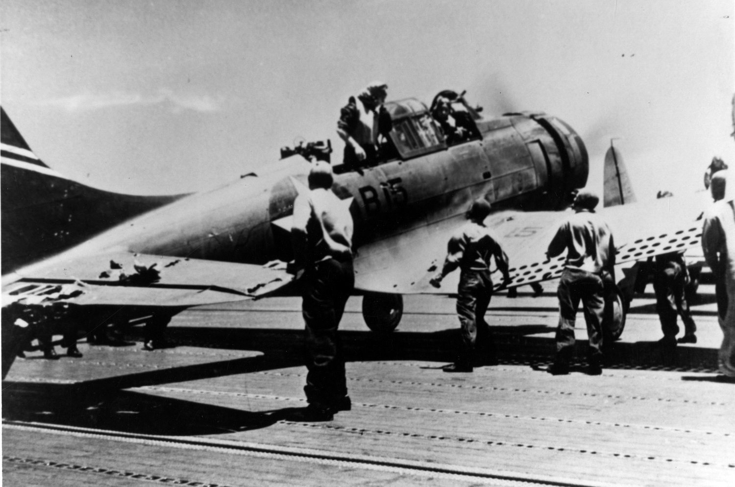 Battle of Midway, June 1942 A Douglas SBD-3 Dauntless scout bomber (Bureau # 4542), of USS Enterprise's Bombing Squadron Six (VB-6), on USS Yorktown (CV-5) after landing at about 1140 hrs on 4 June 1942. This plane, damaged during the attack on the Japanese aircraft carrier Kaga that morning, landed on Yorktown as it was low on fuel. It was later lost with the carrier. Its crew, Ensign George H. Goldsmith, pilot, and Radioman 1st Class James W. Patterson, Jr., are still in the cockpit. Note damage to the horizontal tail. Courtesy of Kent Walters and Robert J. Cressman. 