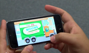 Screenshot of The Big Moving Adventure mobile app in child's hands; click here to download the photo