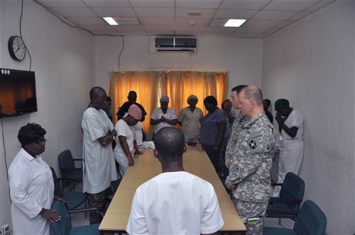 Col. Jim Czarnik, U.S. Army Africa command surgeon and Col. Chris O'Connell, 405th Combat Support Hospital battalion commander, listen to the morning song, prayer and brief from the Ghana Armed Forces 37th Military Hospital intensive care unit staff during Medical Readiness Training Exercise 14-3 in Accra, Ghana. MEDRETE 14-3 was a mutually beneficial exercise that brought together Ghana and U.S. Army medical professionals to foster cooperation while conducting medical specific tasks.