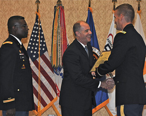 New PM COL William Russell (right) accepting the GFEBS Charter from Mr. Douglas Wiltsie (center), as Former PM COL Patrick Burden (left) looks on.