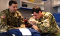 Army Staff Sgt. James Soroka, left, and Army Sgt. Brandon Dukes, both medics assigned to the 82nd Combat Aviation Brigade practice endotracheal intubation. 