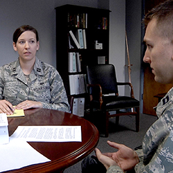 Two service members sitting at a table together