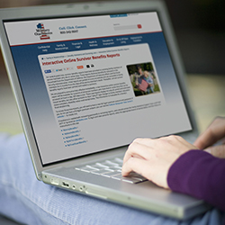 Woman reading “Interactive Online Survivor Reports” on her laptop