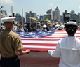 Image of service members with American flag at Fleet Week.