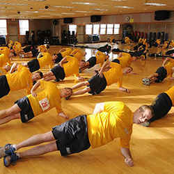 Navy service members in PT working out.