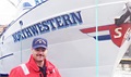 Coast Guard Chief Petty Officer Cody Howard stands in front of the Northwestern from TV's "Deadliest Catch" during his duties in Alaska.