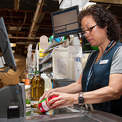 Woman ringing up groceries at the commissary