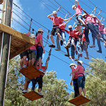 Participants on a high ropes course