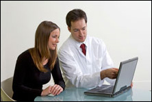 doctor showing patient the computer