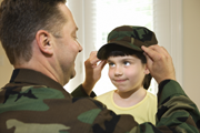 father and his daughter wearing his Army hat